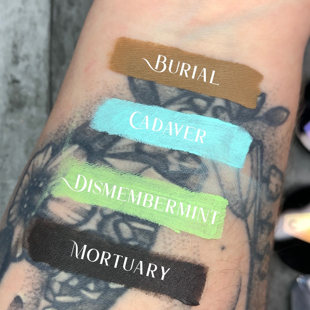 FAIR SKIN TONE ARM SWATCH WITH FUNERAL PROOF EYELINER SWATCHES COVERING OVER TATTOOS #SHADES_BURIAL,CADAVER,DISMEMBERMINT,MORTUARY