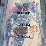 ARM SWATCH OF THE EMBALMING HYDRATING LIPGLOSS IN 
#SHADES_BRUISED,GLOOM,VENOM