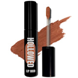 LIP MUD IN BLACK PACKAGING WITH A WINDOW TO SEE COLOR AND NEXT TO THE PRODUCT'S WAND. COLOR SWATCH BEHIND PRODUCT OF A RUSTY NUDE COLOR