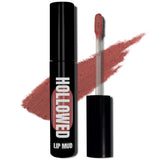 LIP MUD IN BLACK PACKAGING WITH A WINDOW TO SEE COLOR AND NEXT TO THE PRODUCT'S WAND. COLOR SWATCH BEHIND PRODUCT OF A PINK COLOR